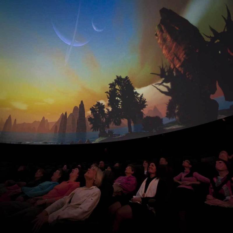 Visitors experience a planetarium show.