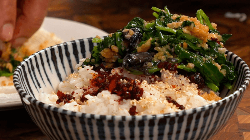 A scallop rice bowl with mustard greens