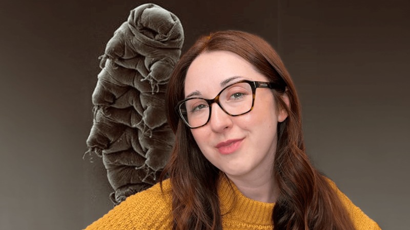 Alex Dainis in front of a tardigrade