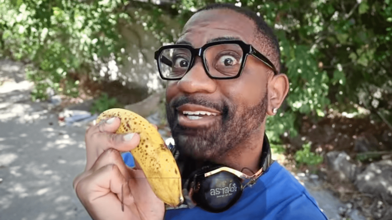 Maynard Okereke holding a banana smiling 