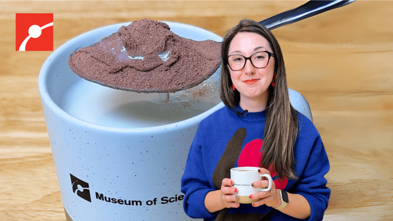 Alex Dainis holding a mug with a spoon of cocoa powder behind her