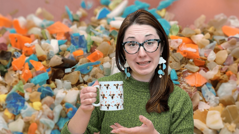 Alex Dainis holding a mug with microplastics in the background