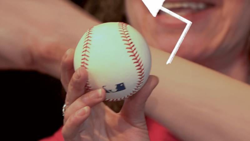 A baseball with an arrow drawn above it