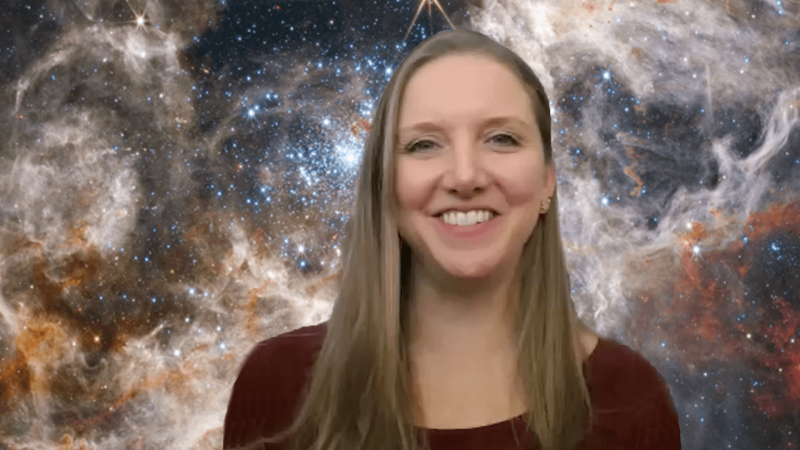 Stefanie Milam in front of a JWST image