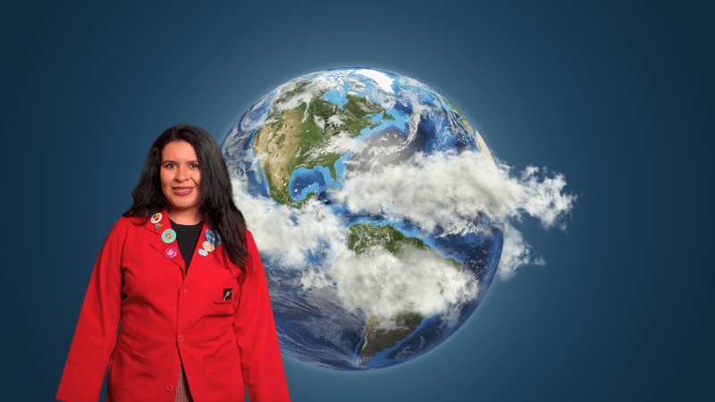 Museum Educator Ana in front of an image of the globe.