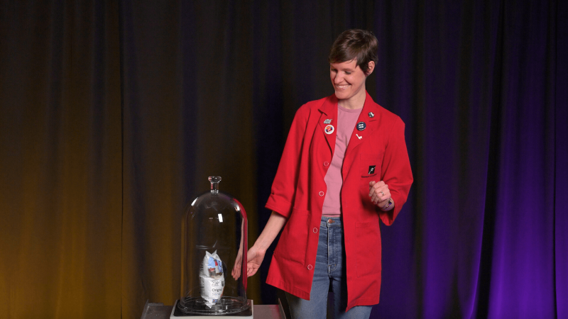 Museum Educator Emily with a bag of chips in a vacuum chamber