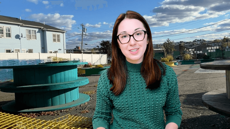 Alex Dainis in front of a future garden space in Chelsea, MA