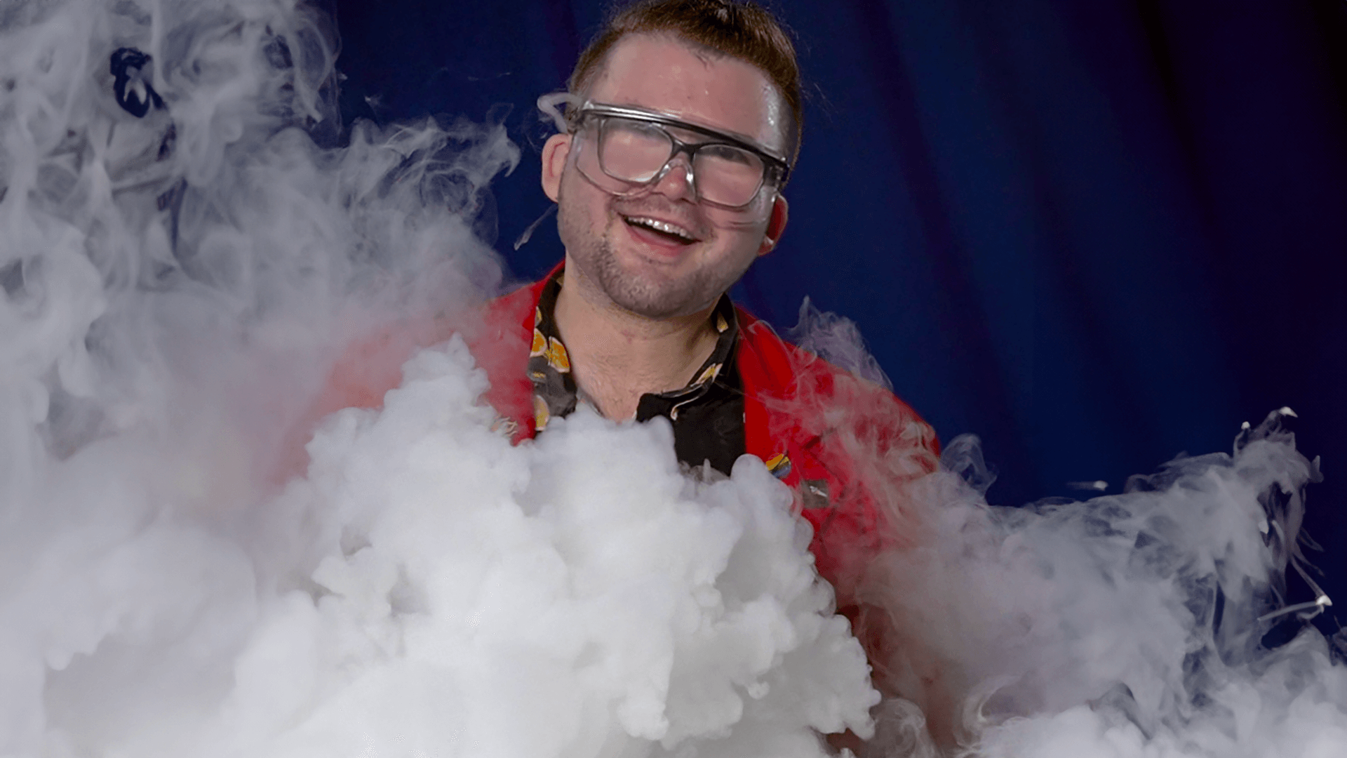 Museum Educator Locke smiling with safety glasses on.