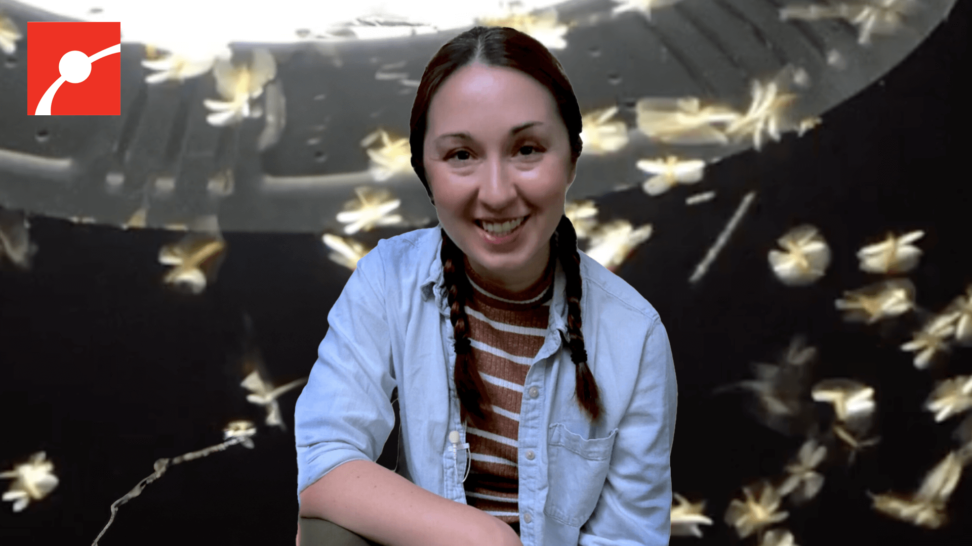 Alex Dainis smiling with bugs flying into a light behind her.