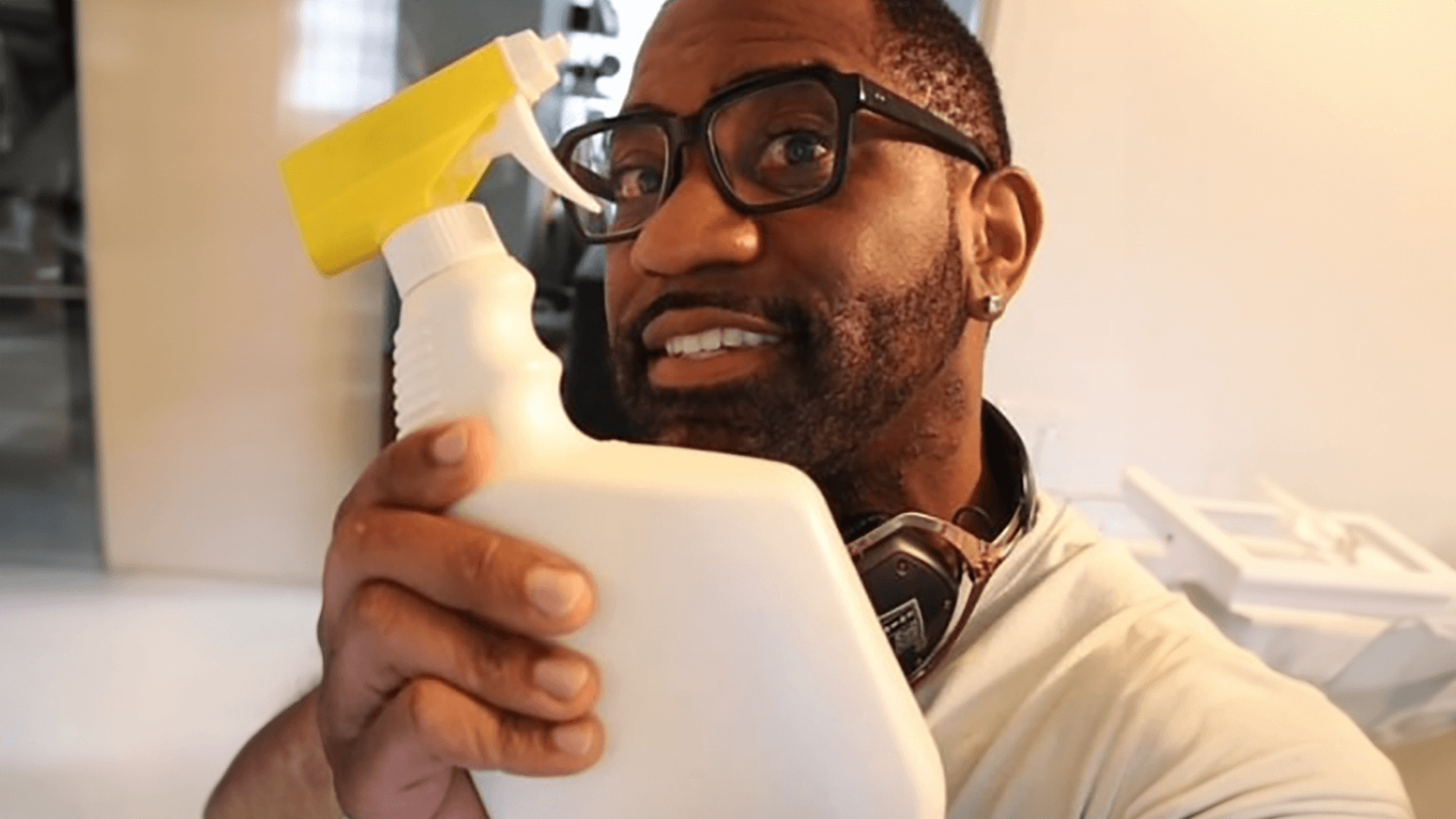 Maynard Okereke holding a cleaning bottle