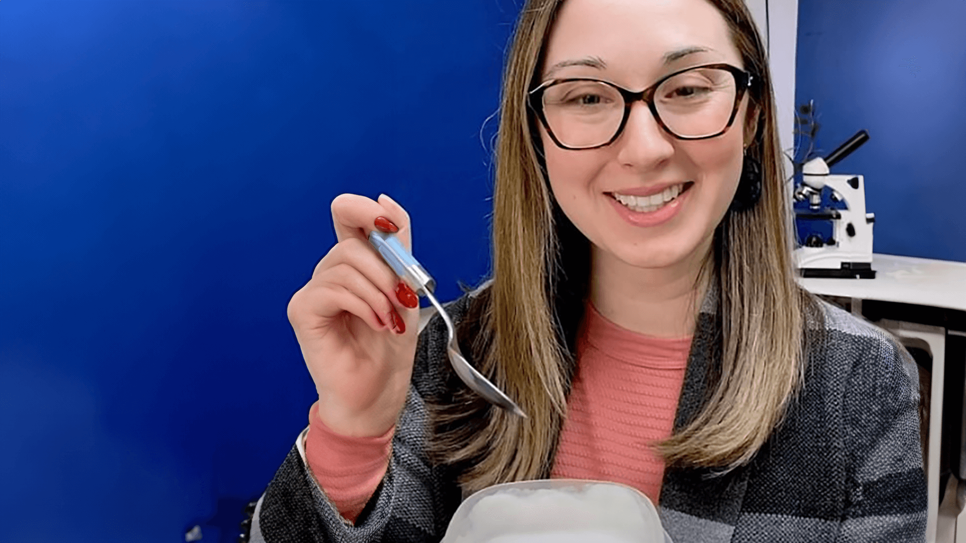 Alex Dainis smiling with a bowl of yogurt