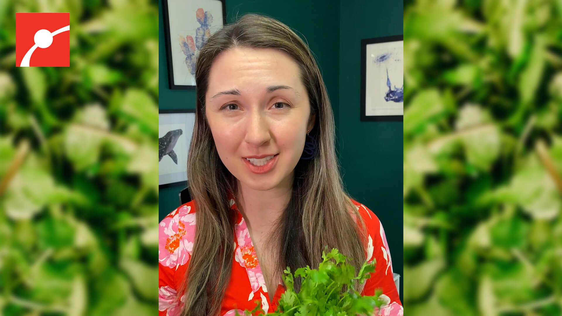 Alex Dainis holding a bunch a cilantro