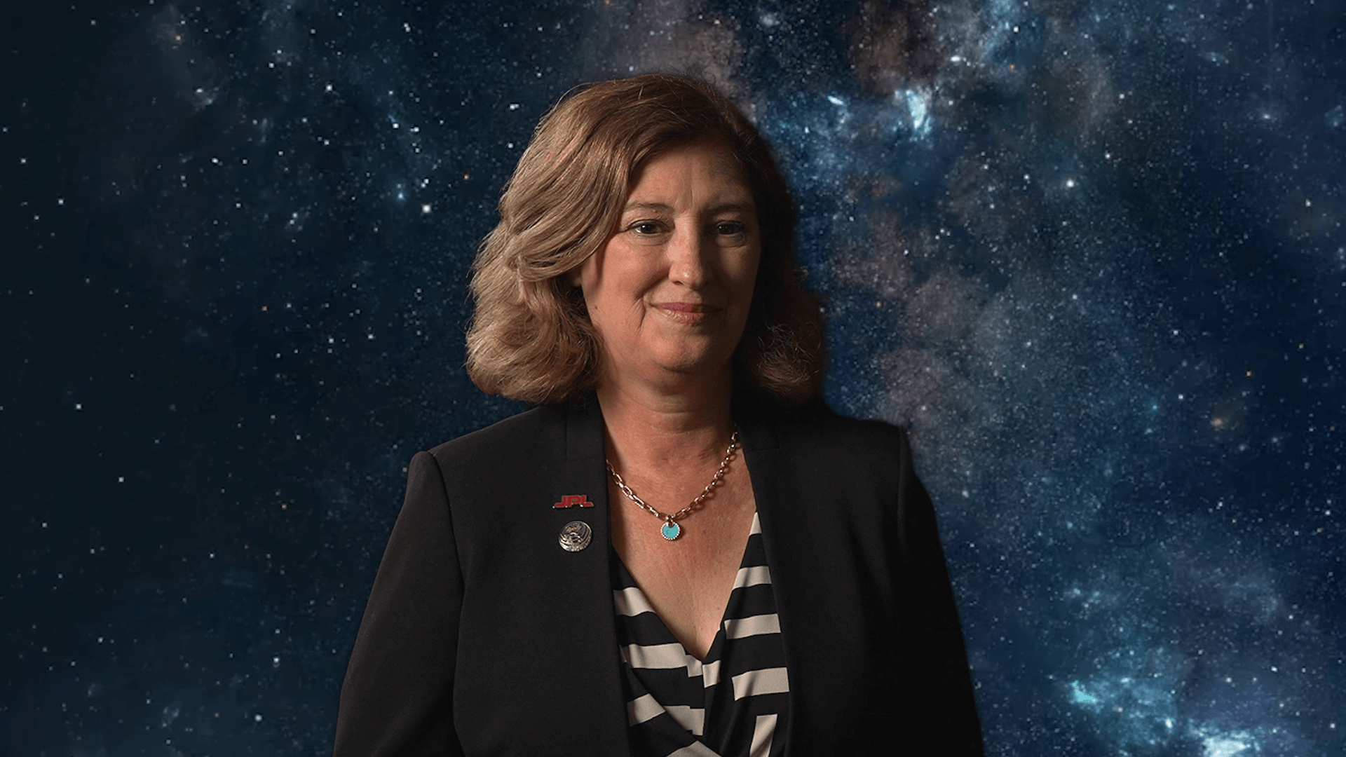 Laurie Leshin and an image of a galaxy