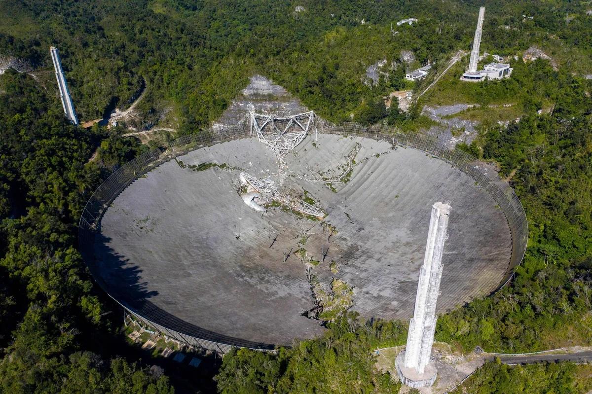 The dish of the Arecibo telescope after the December 1, 2020 collapse of its suspended platform. Credit: Ricardo Adruengo/AFP via Getty Images