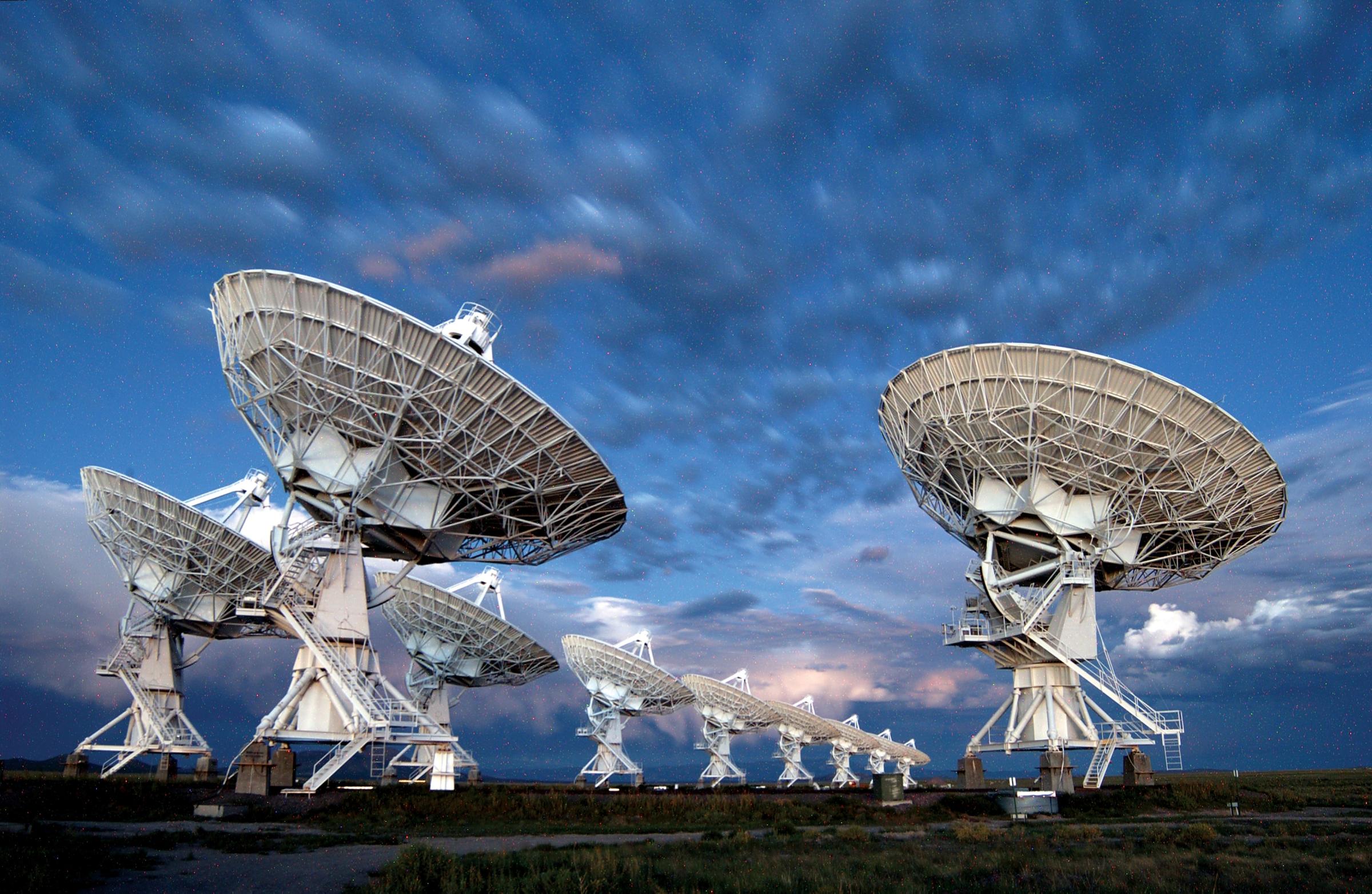 Radio telescopes of the Jansky Very Large Array in New Mexico. Each telescope is about 82 ft (25 m) across and has a traditional radio telescope structure of moveable dish with tripod structure. Credit: NRAO