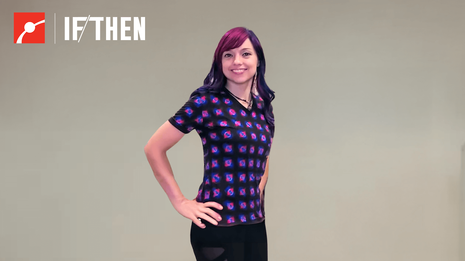 Beata Mierzwa smiles with hands on hips showing a purple and pink t-shirt