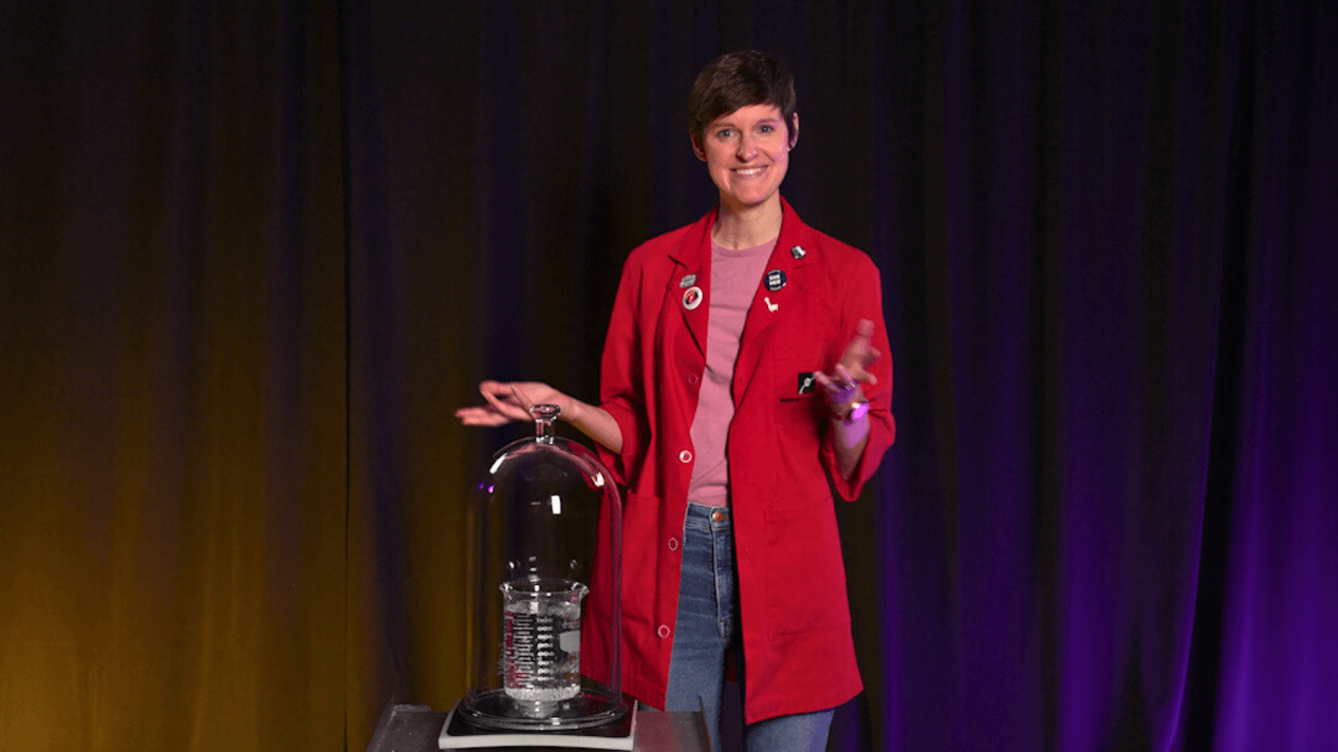 Museum Educator Emily with a beaker of water inside a vacuum chamber