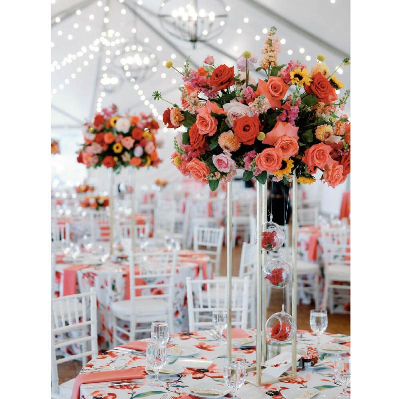 A beautiful table setting with orange and pink flowers.