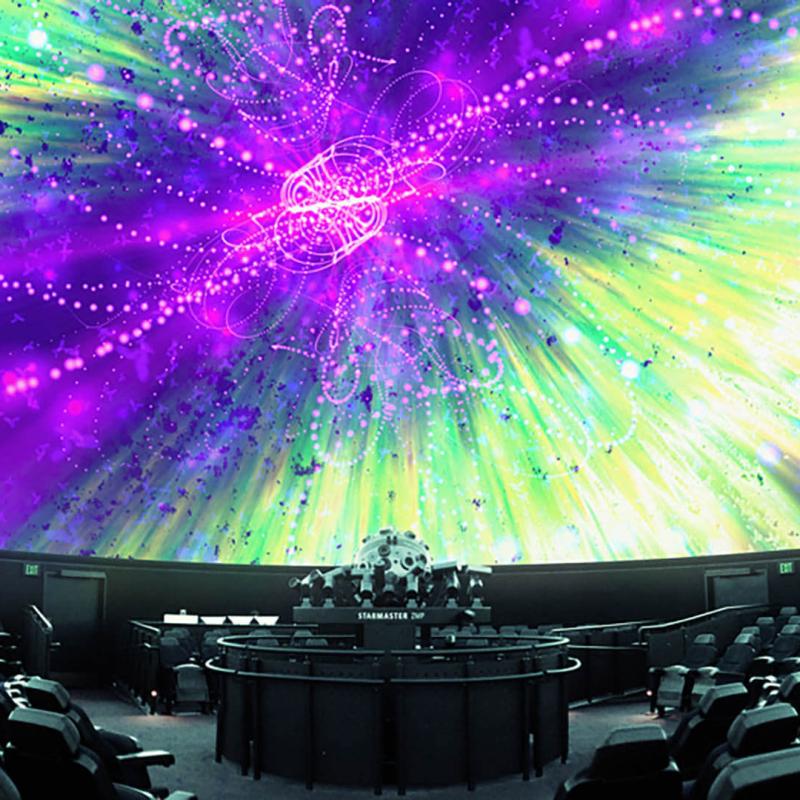 Colorful abstract shapes are projected on the planetarium dome.