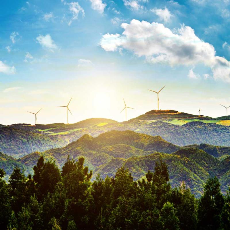 A beautiful landscape with windmills in the distance.